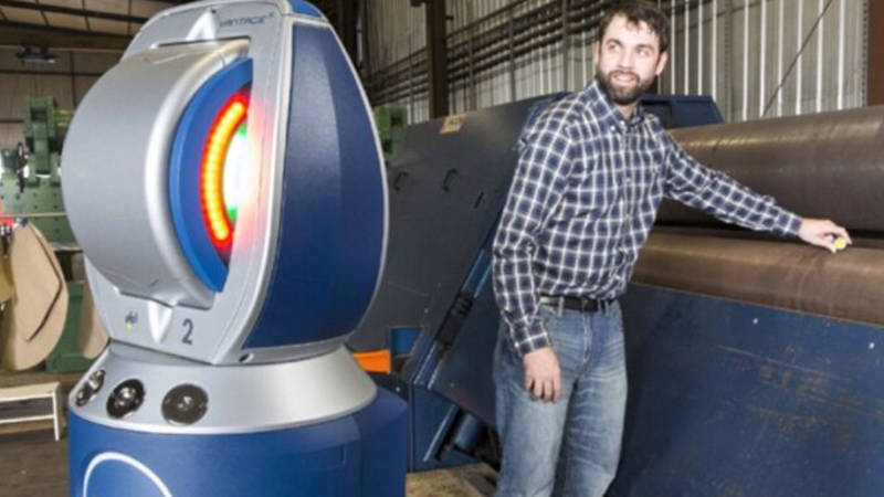 A worker using a laser tracker to check machine alignment