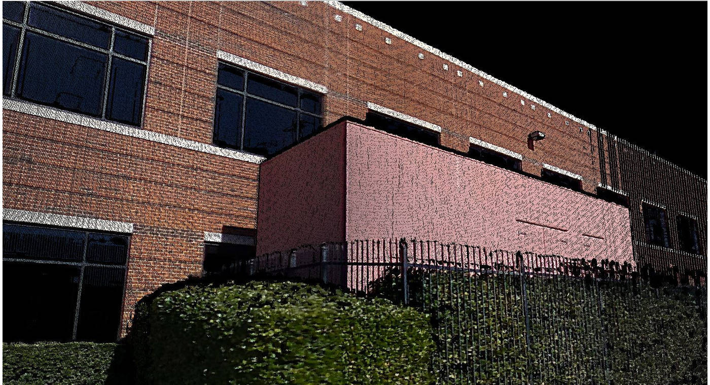 Point cloud data of the side of a building, metal fence and greenery