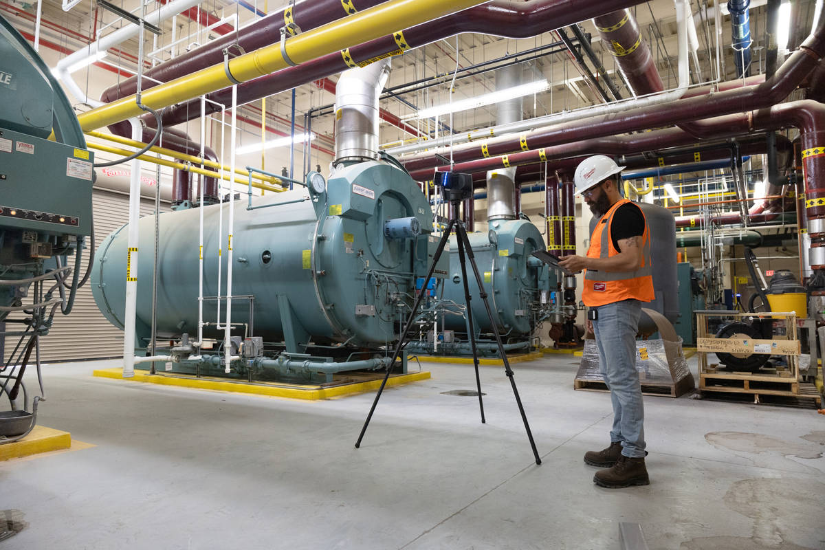  A man mapping a boiler room using a FARO Blink imaging laser scanner in personal protection clothing