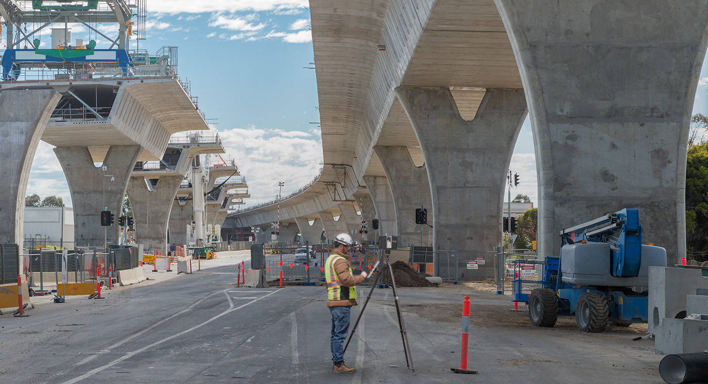 A bridge under construction with a man in ppe scanning using a FARO Focus terrestrial laser scanner
