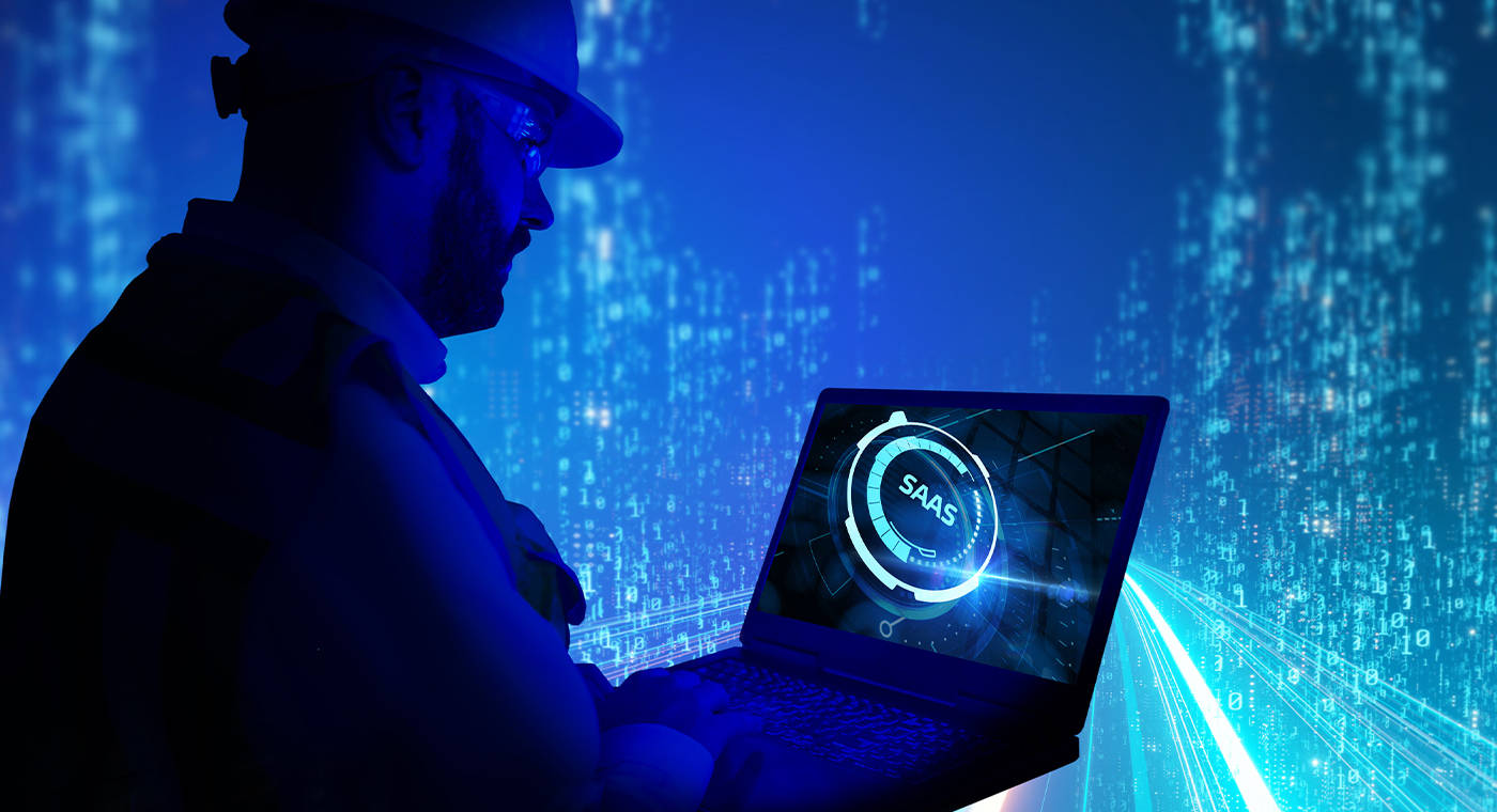 Professional checking on Laptop screen the software as a service abreviation