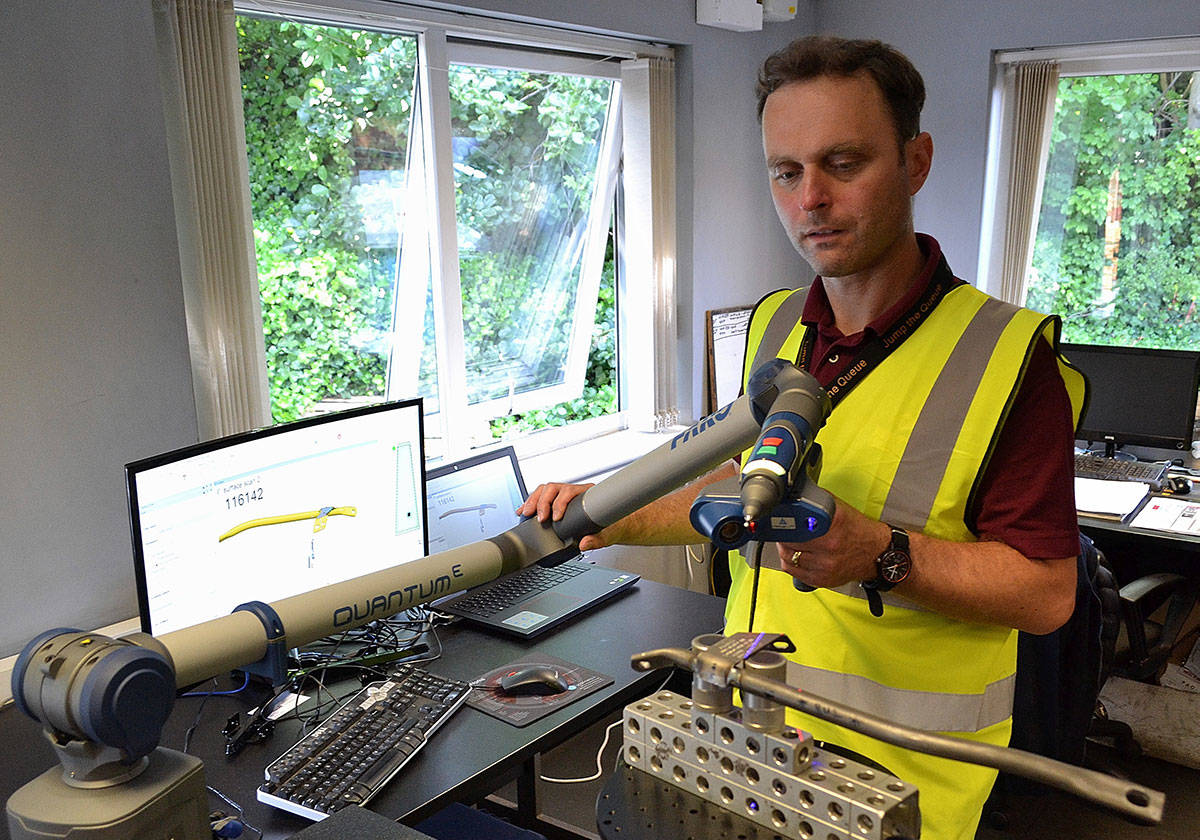 A director of quality speaking into a walkie-talkie during quality control inspection