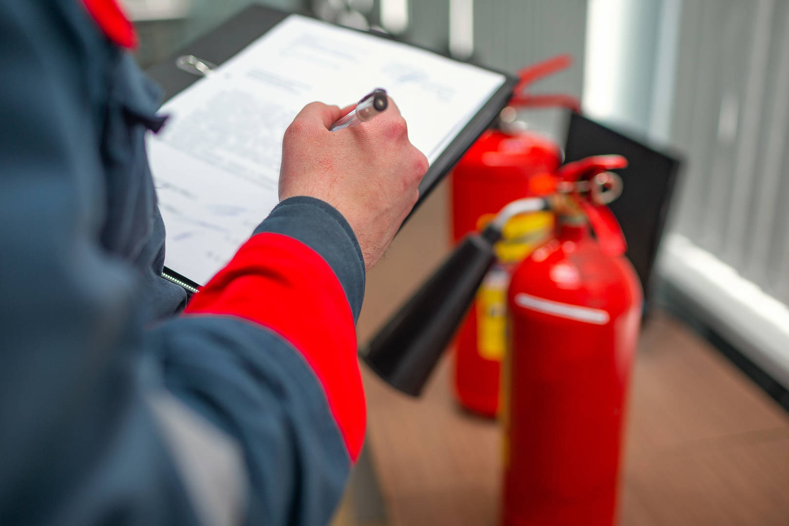 Engineer Professional checking a Fire Extinguisher using clipboard