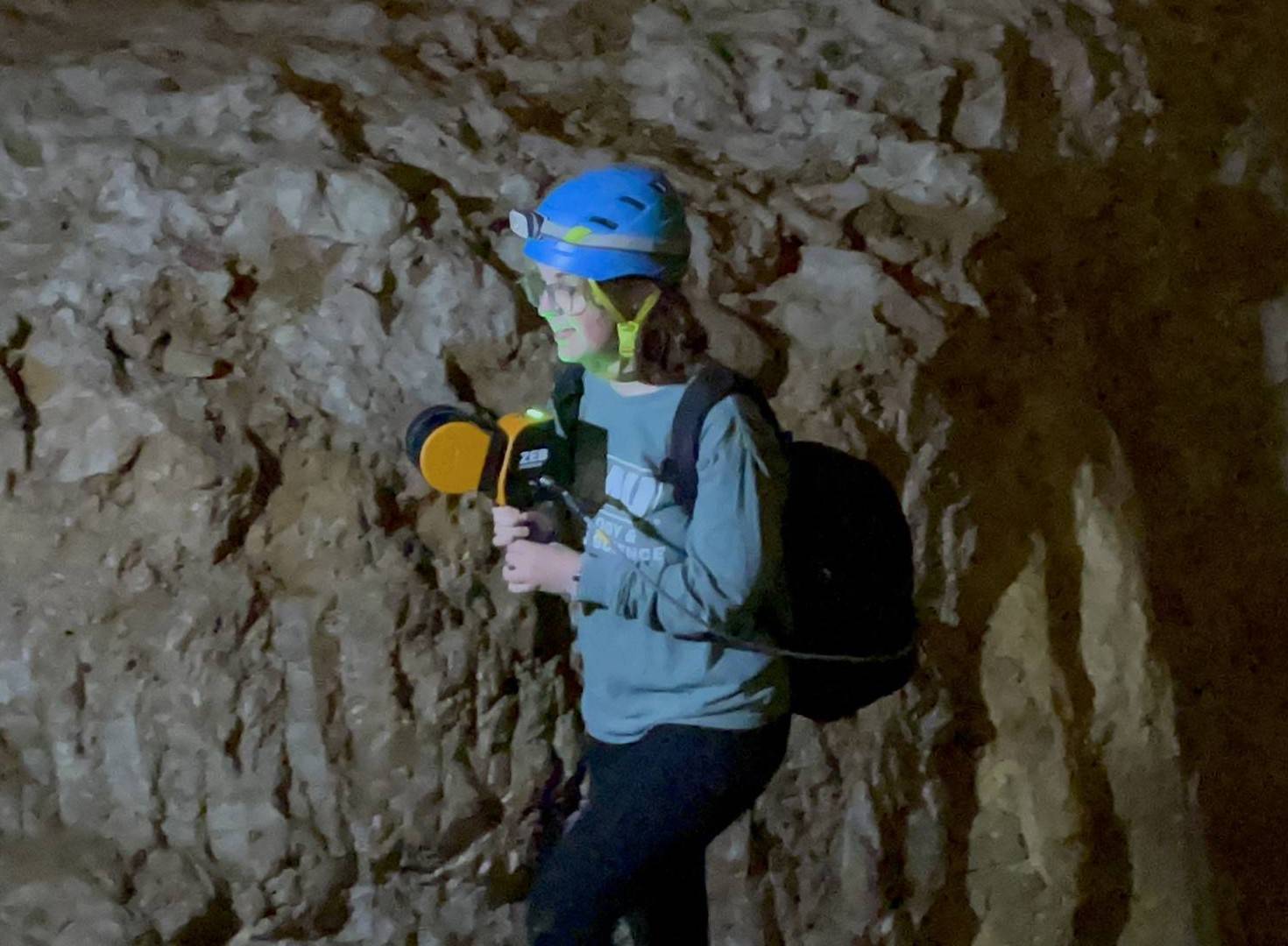 Woman holding a laser scanner in the caverns