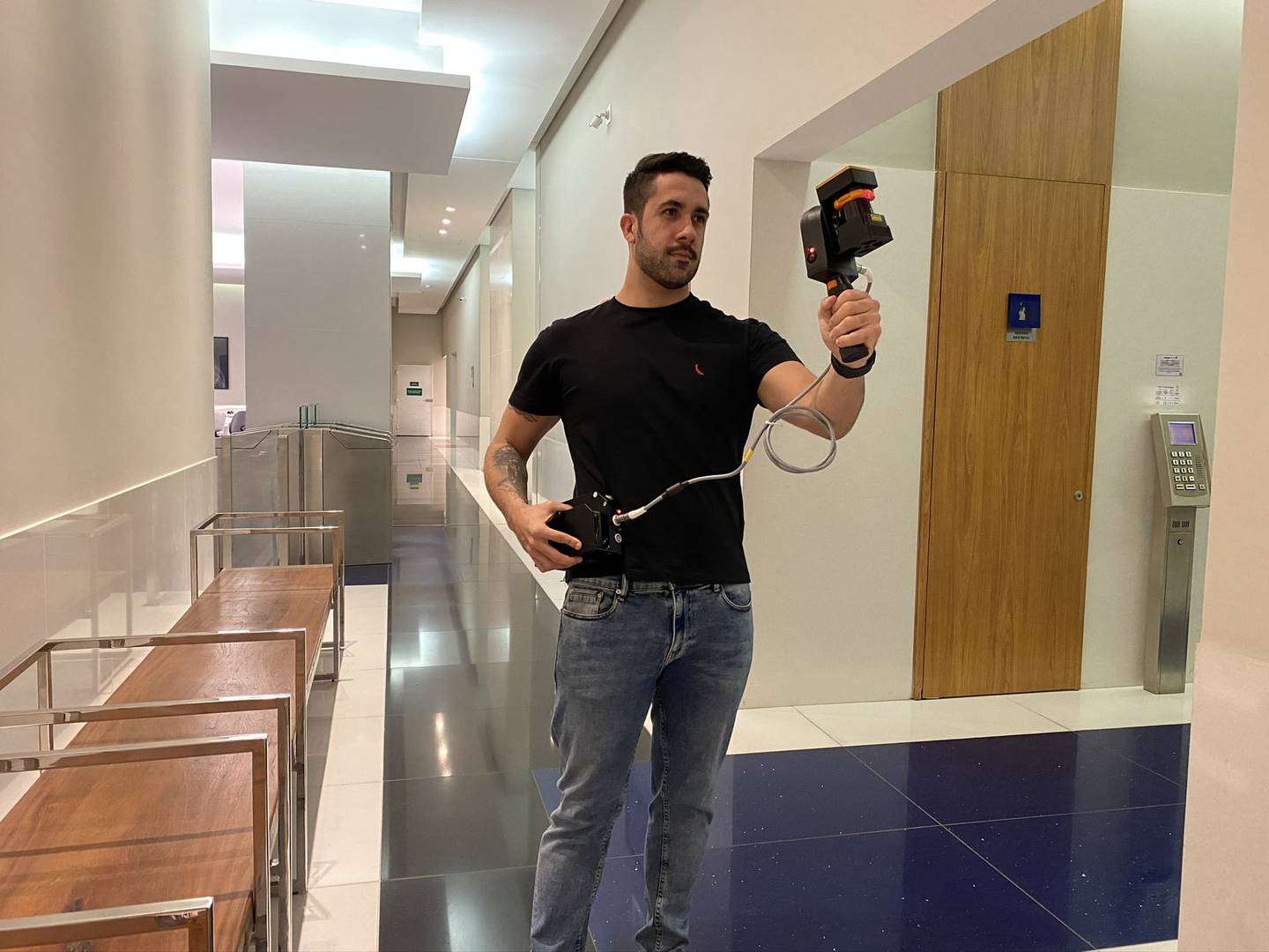 Man scanning in a corridor with mobile LiDAR
