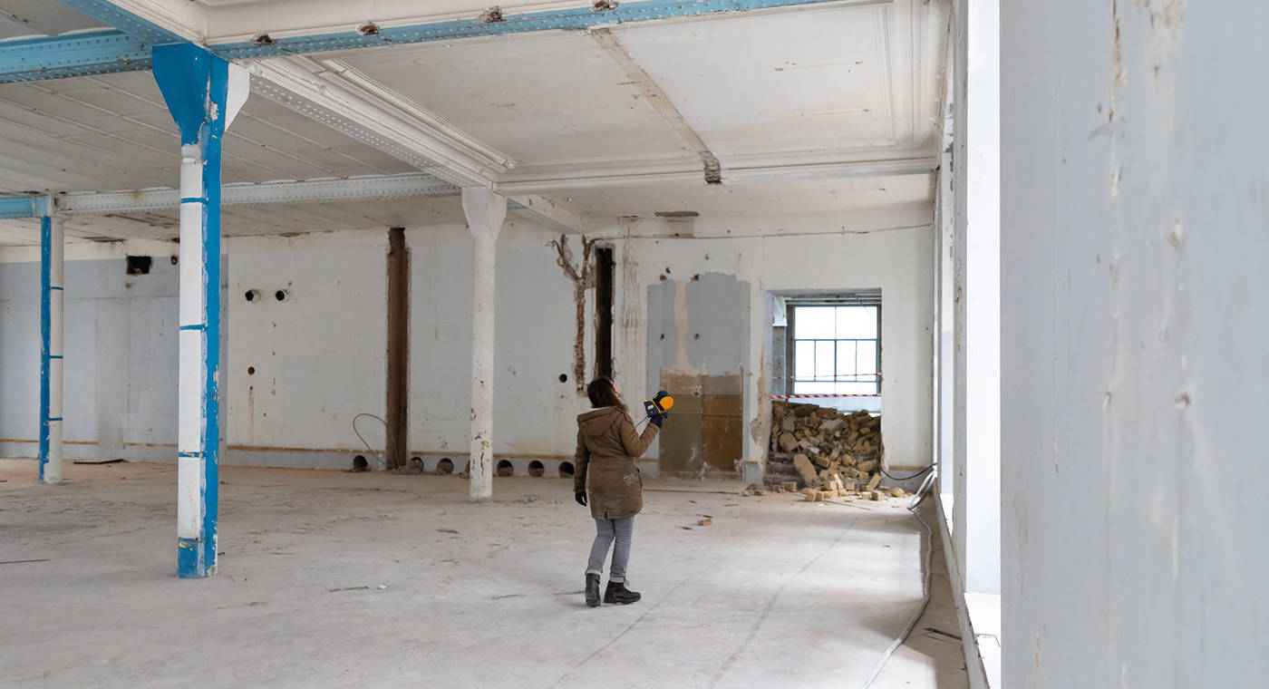 Lady scanning in an abandoned building using mobile LiDAR