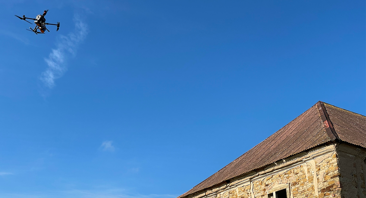 Drone with mobile LiDAR scanner mounted scanning an abandoned warehouse