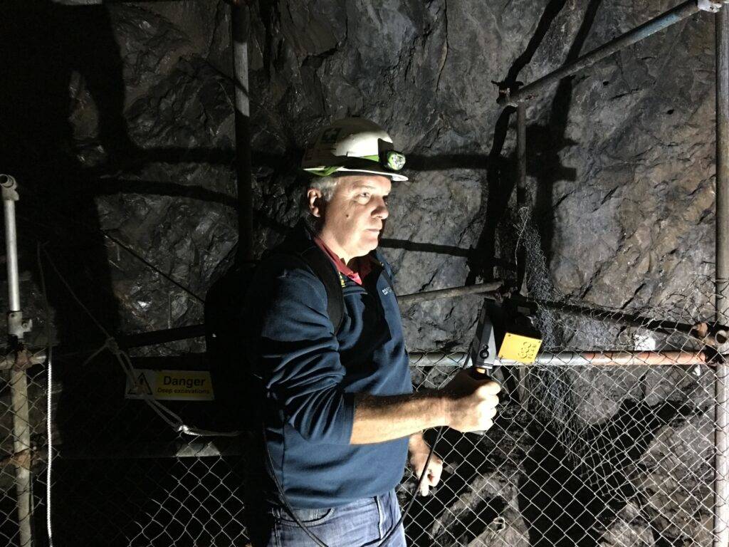 Man using mobile LiDAR to map a cave