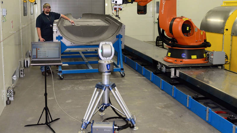 A Cirrus Aircraft worker uses a FARO Laser Tracker for robot and machine tool calibration