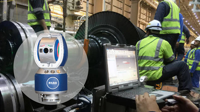 A laptop displaying a FARO 3D scan of a wind turbine with workers checking precision measurements in the background