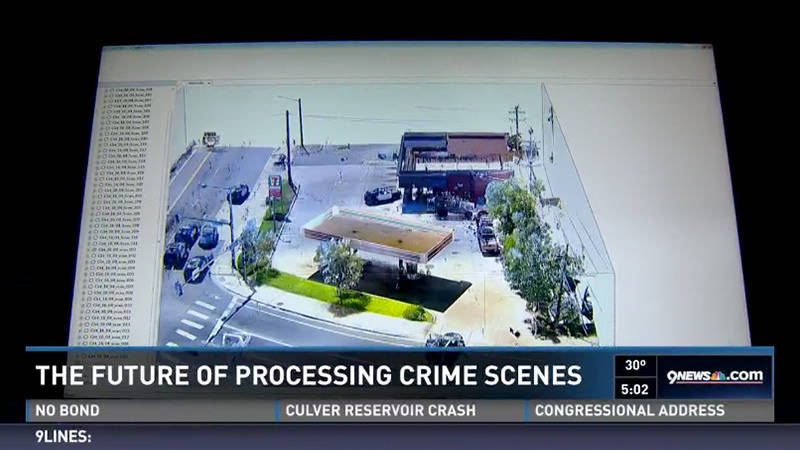 A 3D scanning image of a gas station on a TV news segment about the future of processing crime scenes