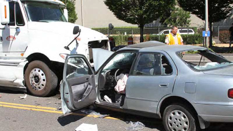 A crash scene involving a car and a semitruck